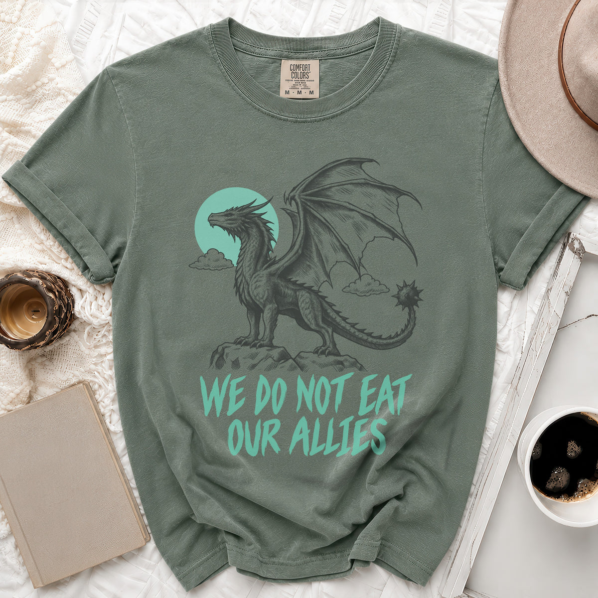Green t-shirt with a dragon graphic and the text "We do not eat our allies".