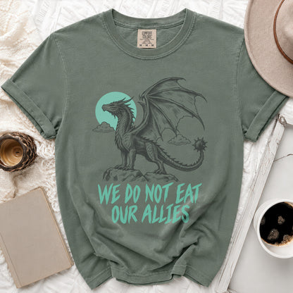 Green t-shirt with a dragon graphic and the text "We do not eat our allies".