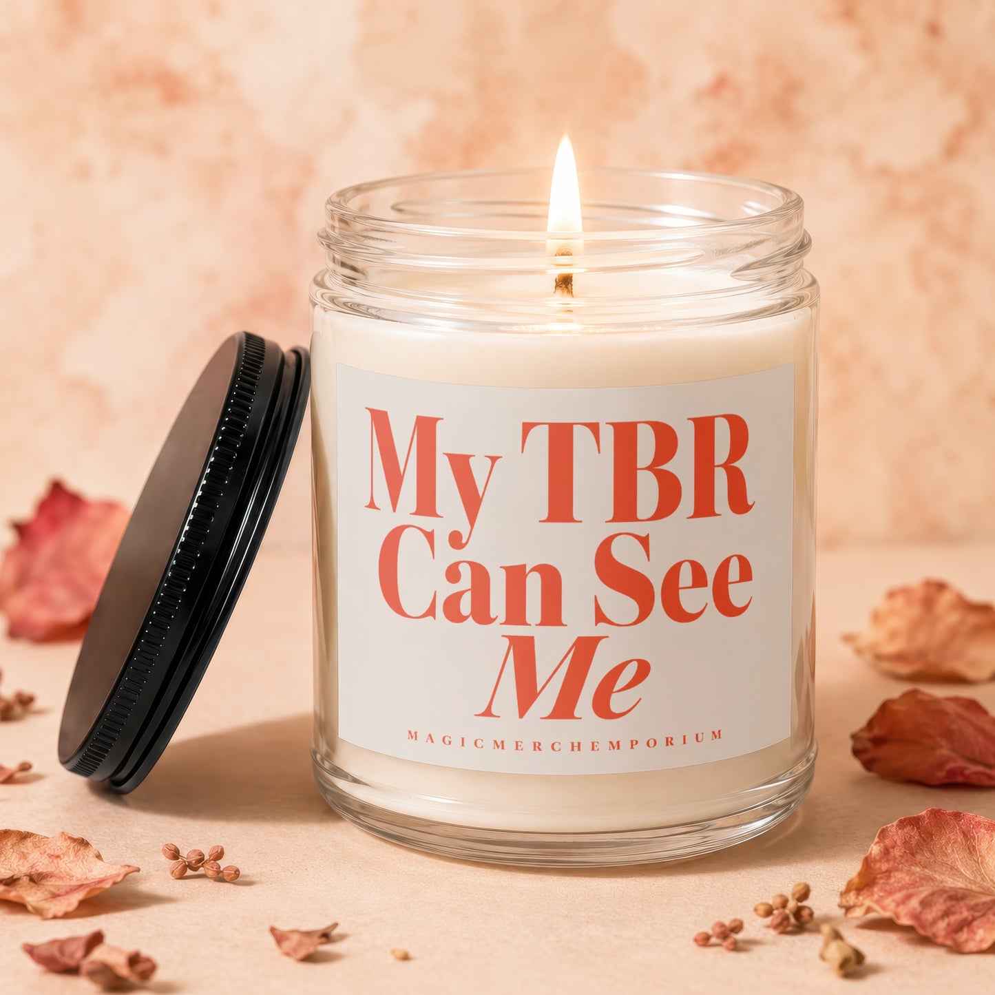 Glass candle labeled "My TBR Can See Me" with a lit wick.