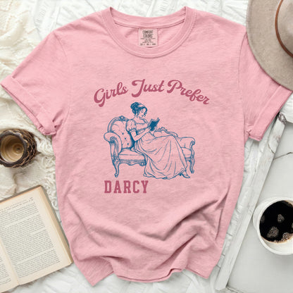 Pink t-shirt with "Girls Just Prefer Darcy" and book-reading woman graphic.