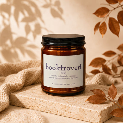 Amber candle with "booktrovert" definition label on white background.