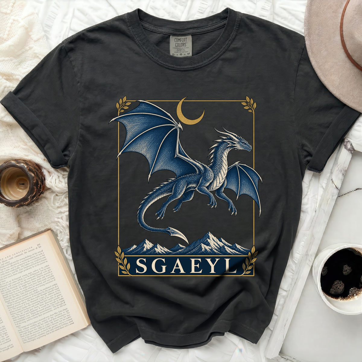 Dark grey t-shirt with a blue dragon, moon, mountains, and text "SGAEYL".