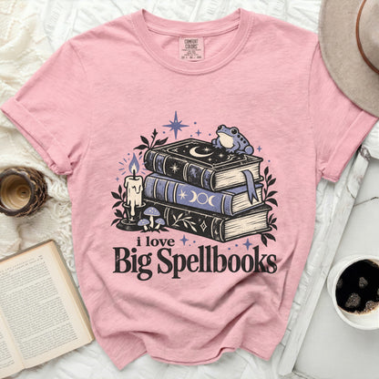 Pink t-shirt with "i love Big Spellbooks" graphic featuring books, frog, and candle.