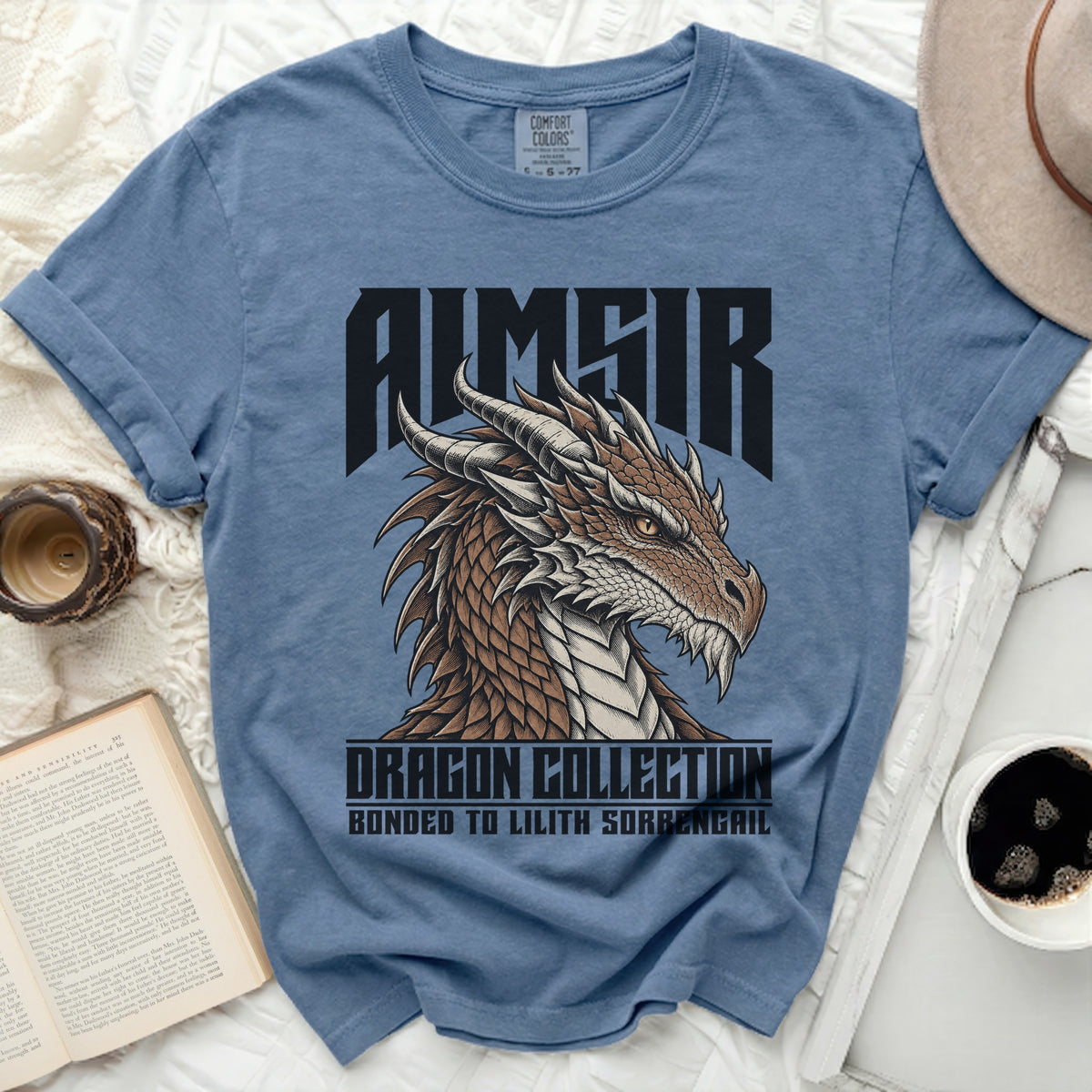 Blue t-shirt with a dragon design and text "AIMAIR DRAGON COLLECTION BONDED TO LILITH SORBENGAIL".