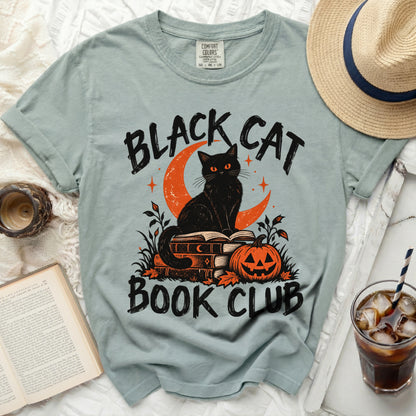 Light blue t-shirt with "Black Cat Book Club" text, cat, moon, books, and pumpkin graphic.