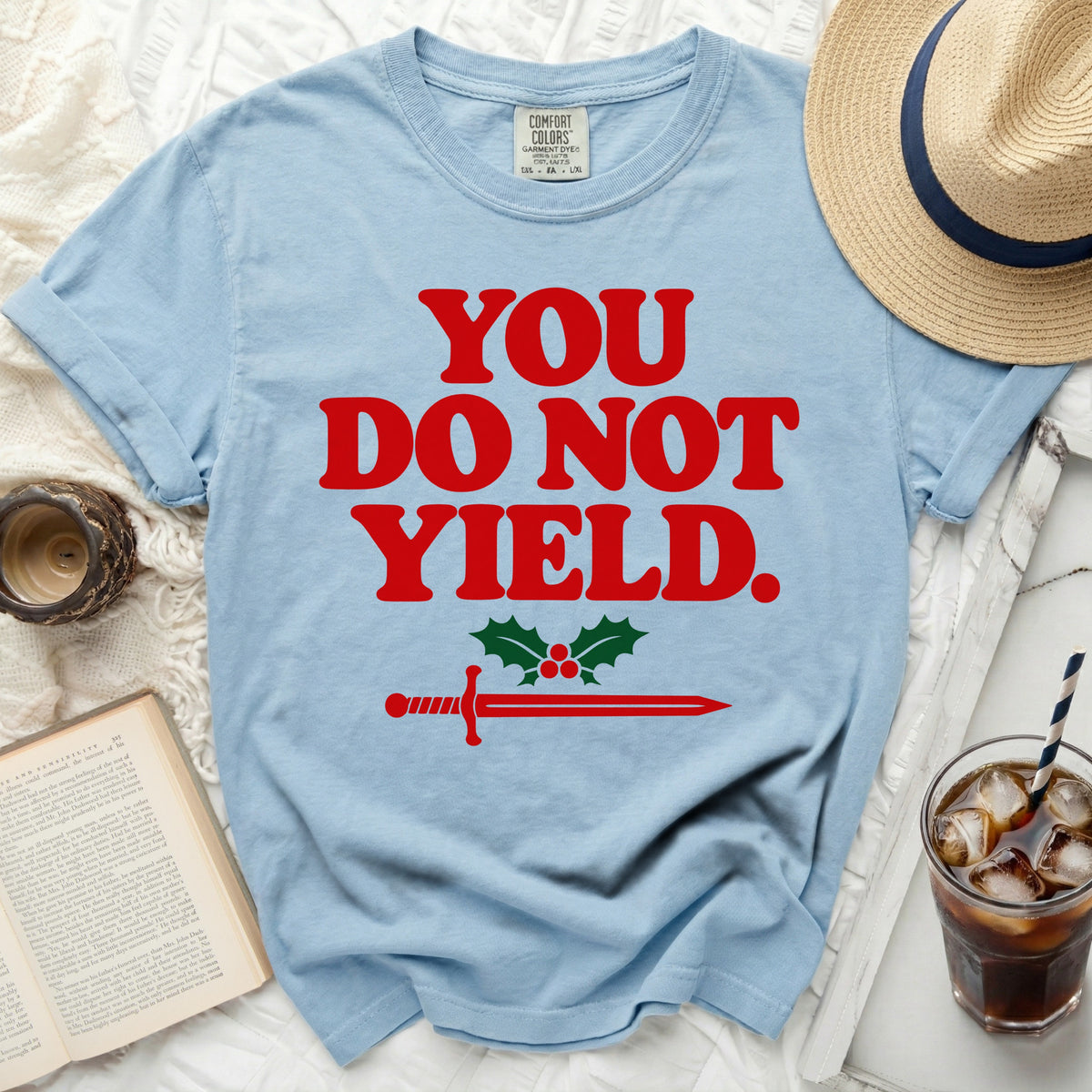Light blue t-shirt with red text "YOU DO NOT YIELD" and sword graphic.
