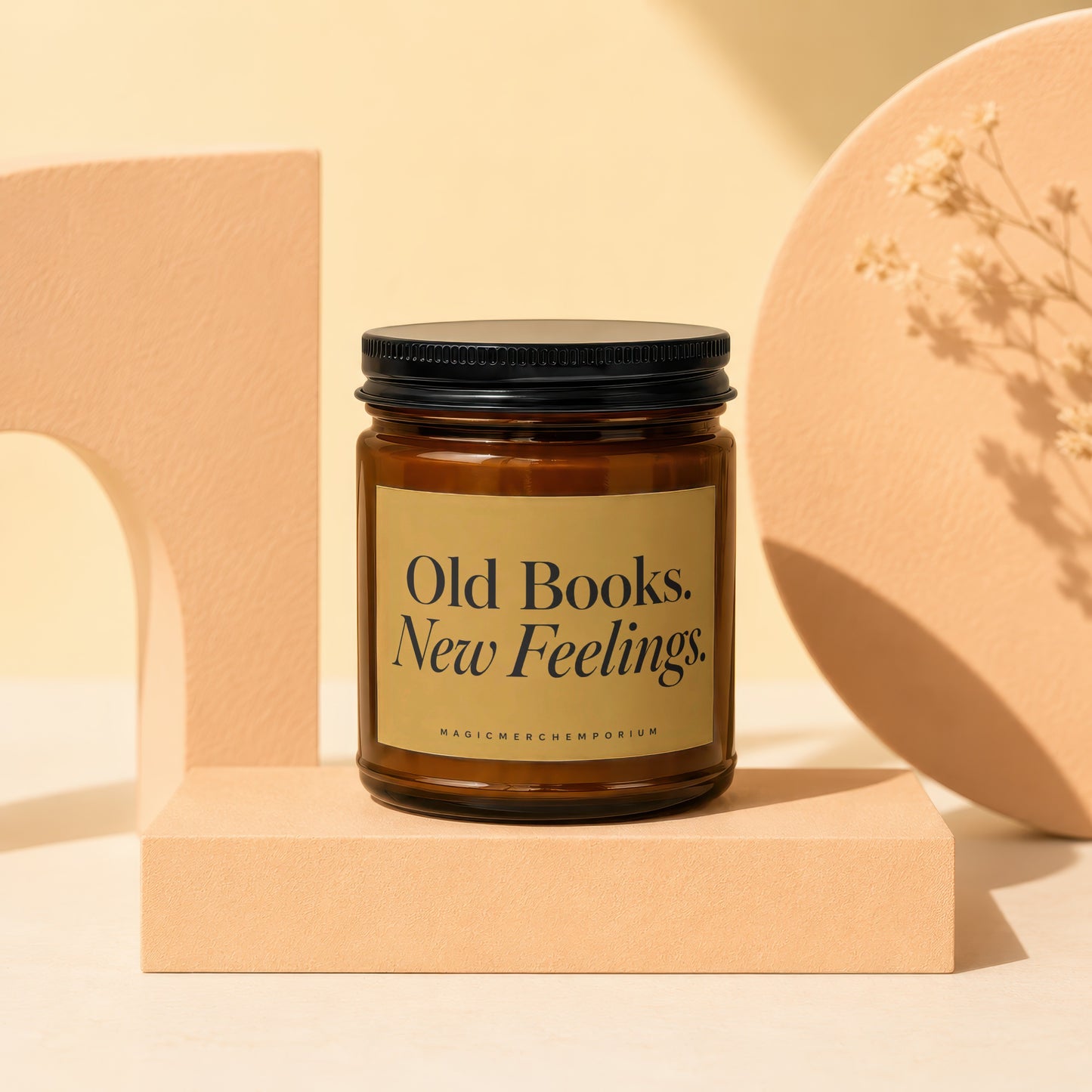 Amber jar candle with black lid reads "Old Books. New Feelings."