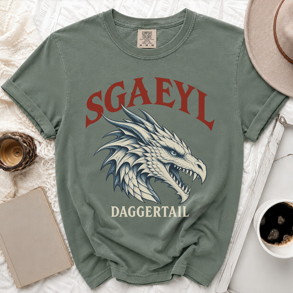 Sage green t-shirt with a white dragon head and "SGAEYL DAGGERTAIL" text.
