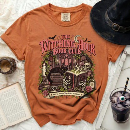 Orange t-shirt with "The Witching Hour Book Club" graphic featuring a black cat, skull, books, and potion.