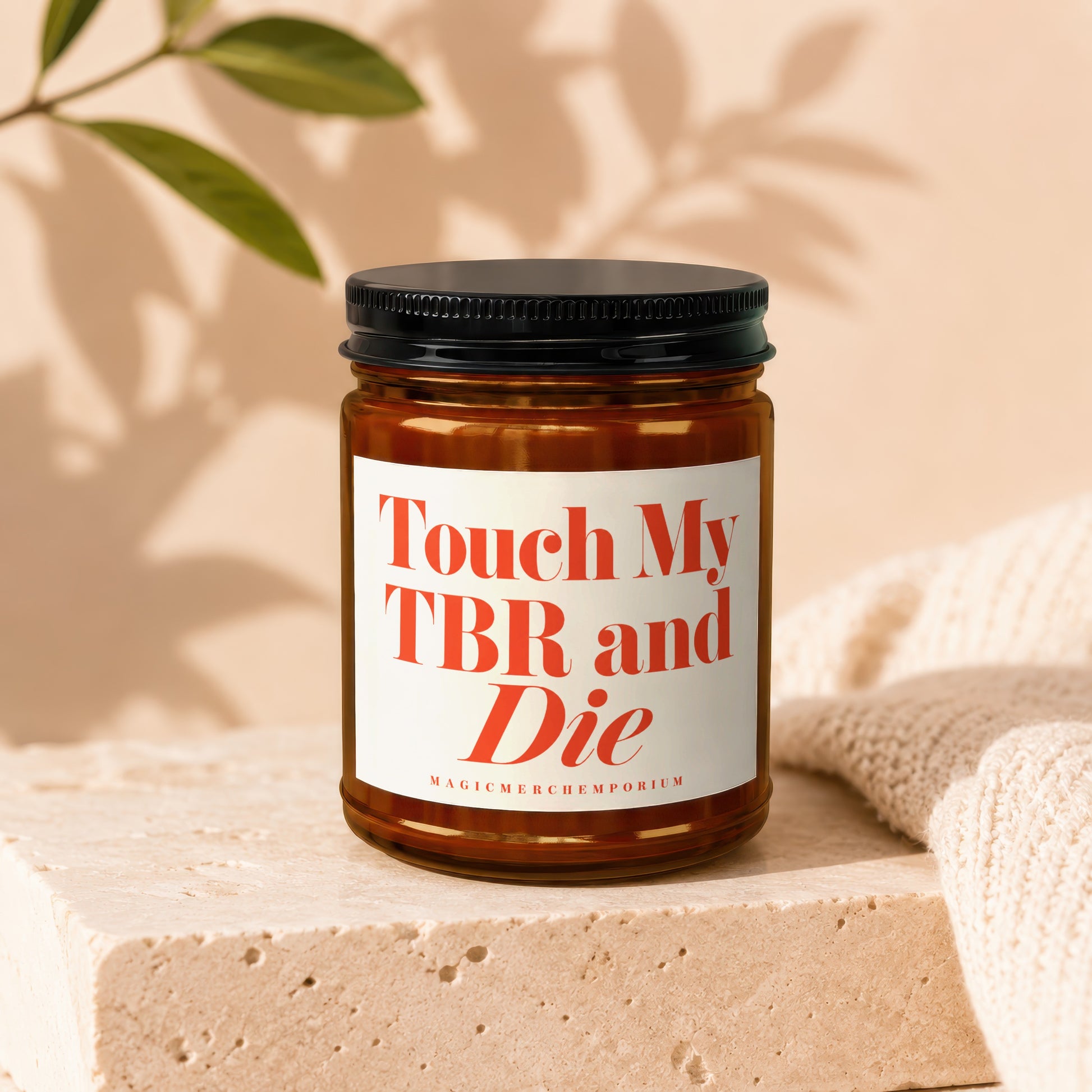 Amber candle with white label reading "Touch My TBR and Die"