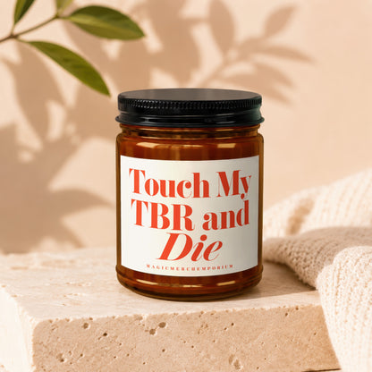 Amber candle with white label reading "Touch My TBR and Die"