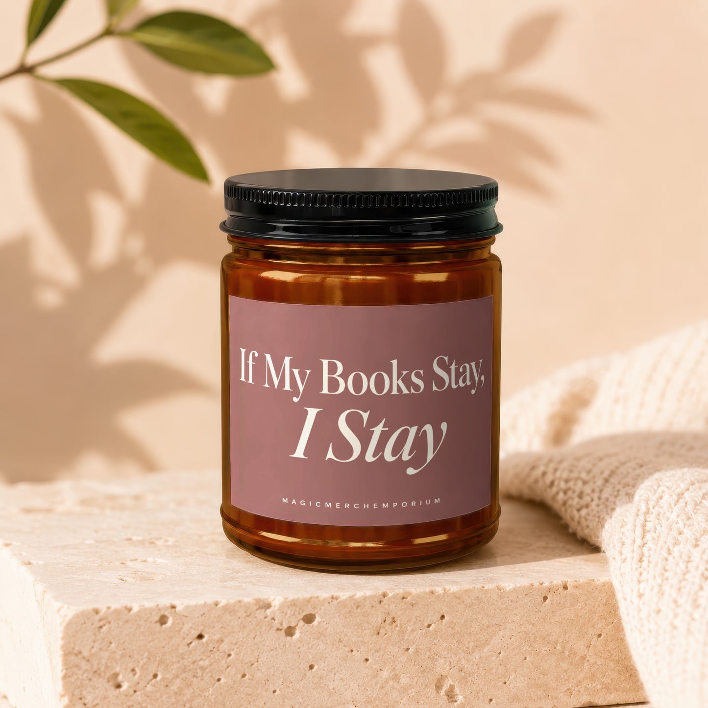 Amber jar candle with pink label reading "If My Books Stay, I Stay".
