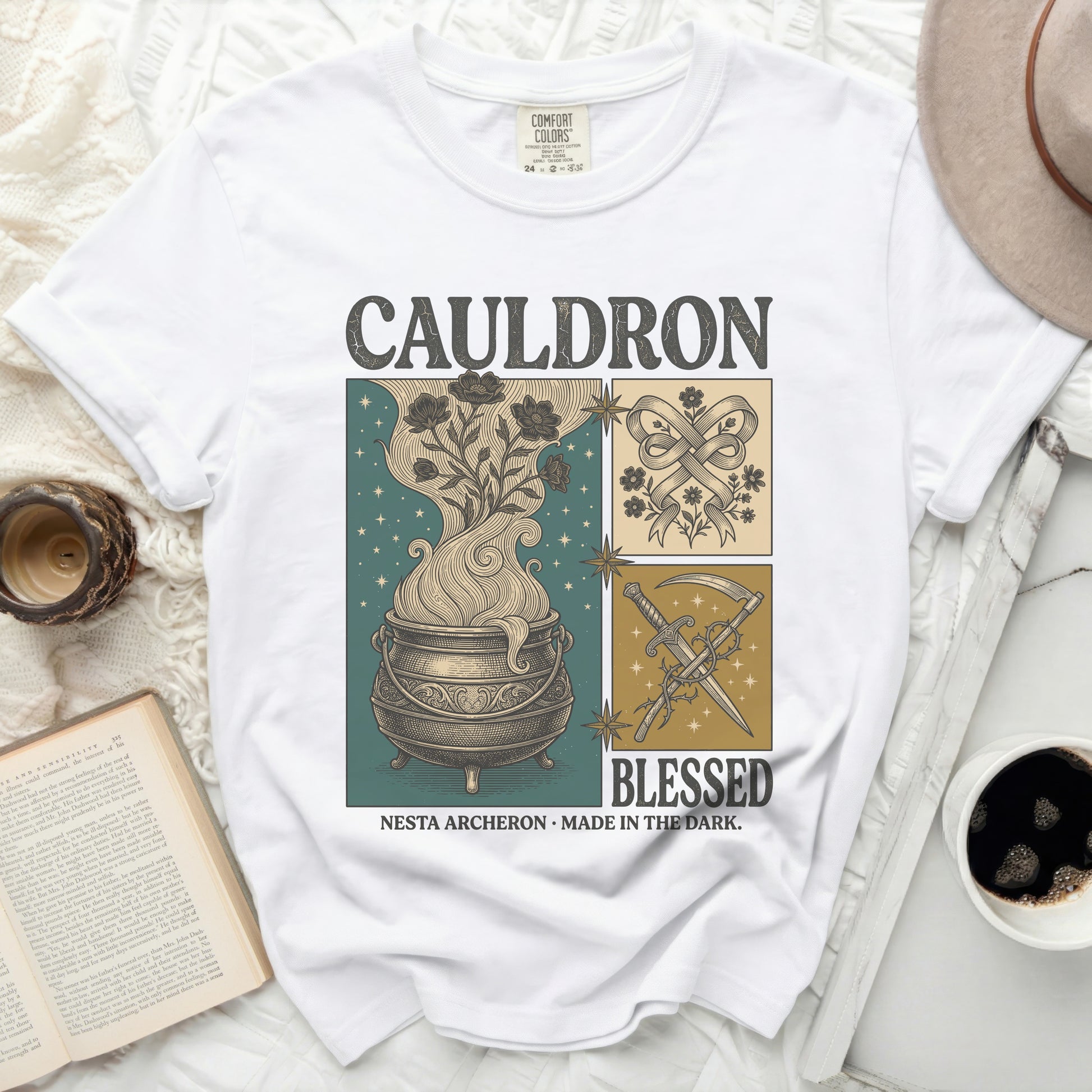 White Comfort Colors t-shirt with "CAULDRON BLESSED NESTA ARCHERON MADE IN THE DARK" graphic.