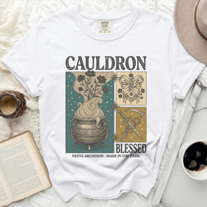 White Comfort Colors t-shirt with "CAULDRON BLESSED NESTA ARCHERON MADE IN THE DARK" graphic.