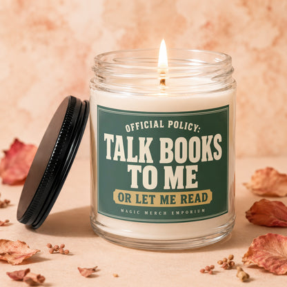 Candle with lit flame and label reading "Official Policy: Talk Books to Me or Let Me Read".