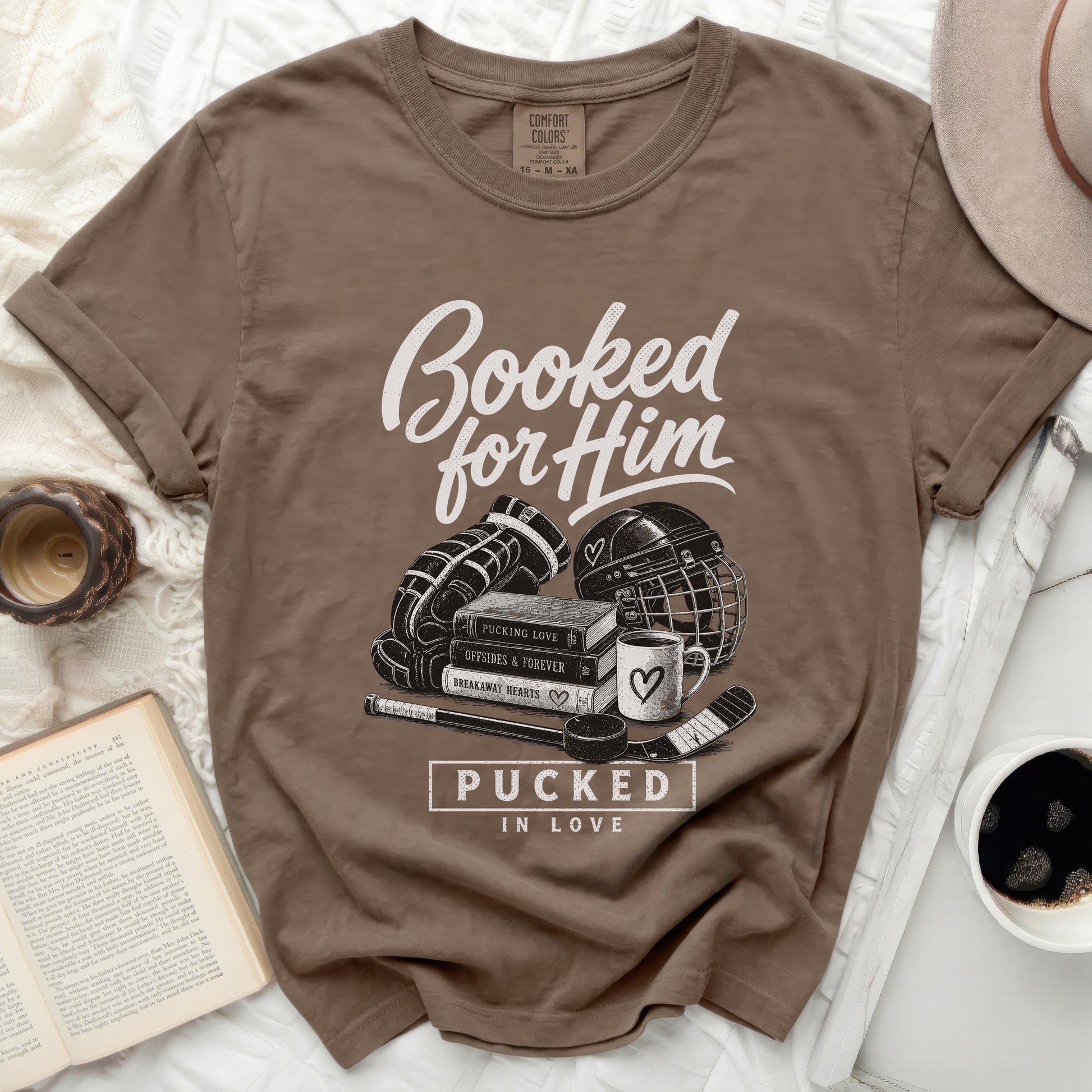 Brown t-shirt with "Booked for Him" and hockey graphic.