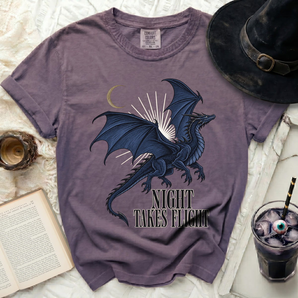 Purple t-shirt with a dark blue dragon graphic and text "NIGHT TAKES FLIGHT".