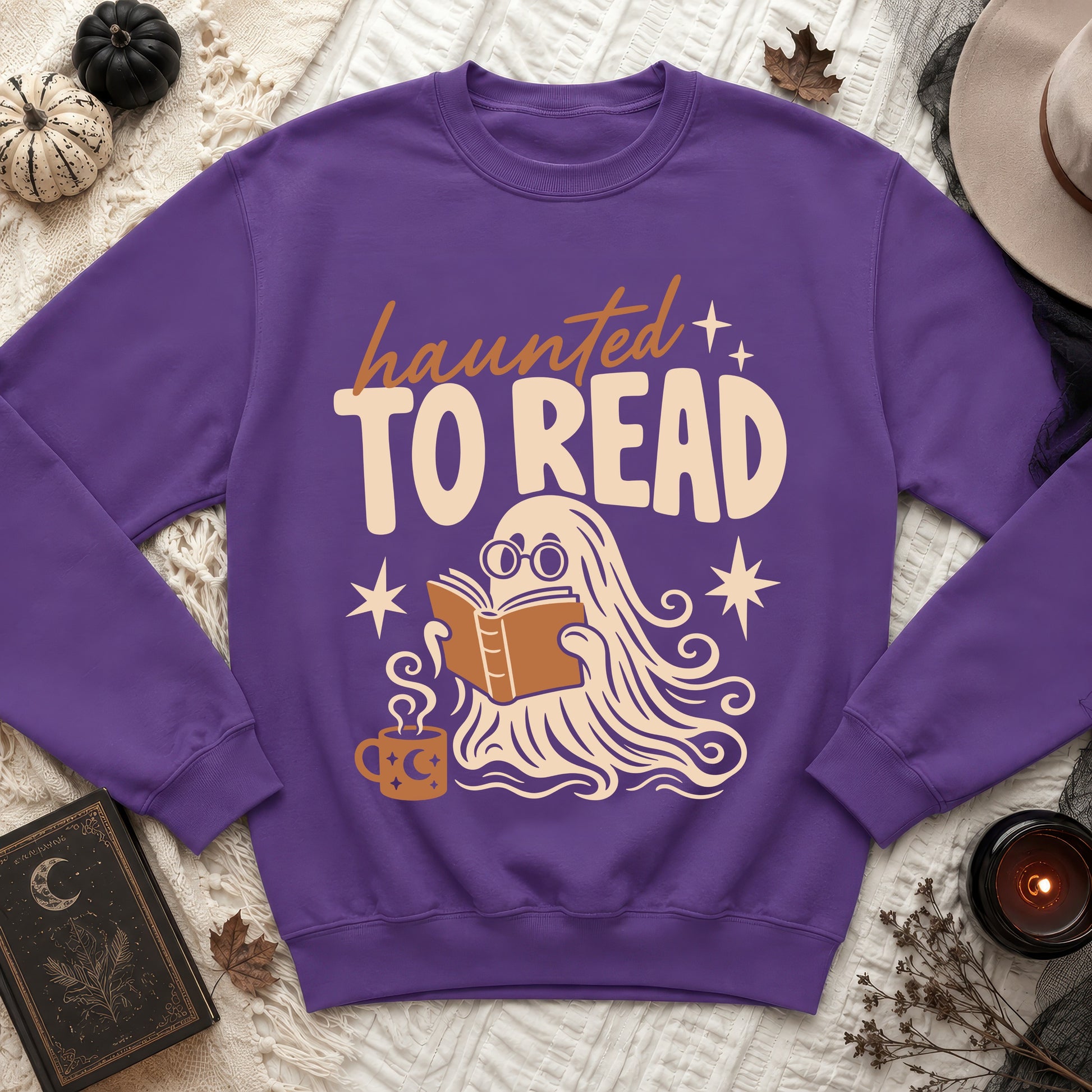 Purple sweatshirt with ghost reading book and text "haunted TO READ".