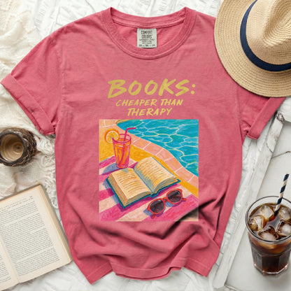 Pink t-shirt with "Books: Cheaper Than Therapy" graphic.