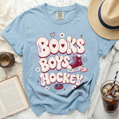 Light blue t-shirt with "Books Boys Hockey" text and ice skate graphic.