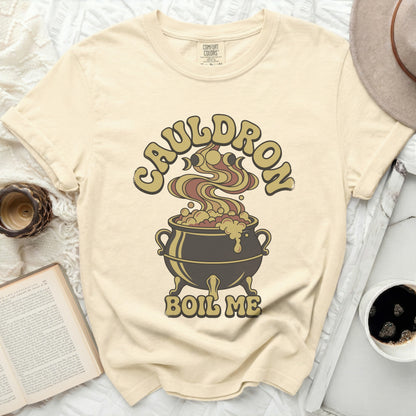 Cream t-shirt with "Cauldron Boil Me" graphic of a cauldron and moon phases.