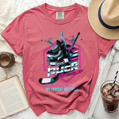 T-shirt with hockey skates, puck, stick, and text "Puck Paperbacks Books. Ice. Feels. My Perfect Hat Trick."