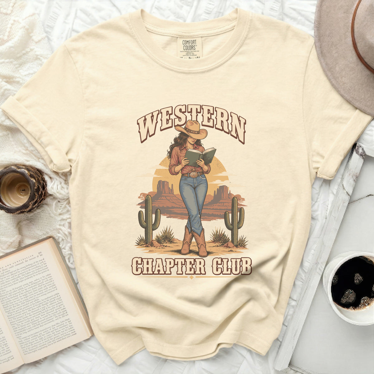 T-shirt with "Western Chapter Club" graphic of cowgirl reading in desert.