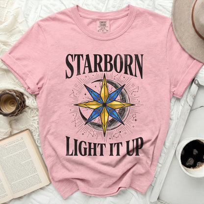 Pink t-shirt with "STARBORN LIGHT IT UP" and star compass graphic.