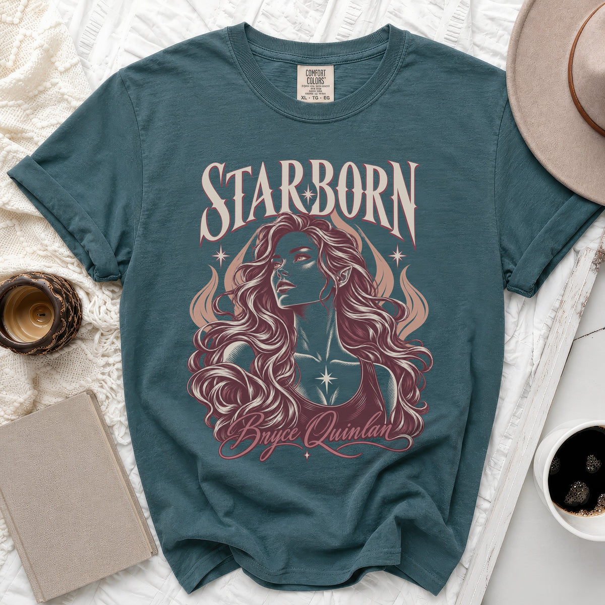 Teal t-shirt with "Starborn" and "Bryce Quinlan" text and illustration.