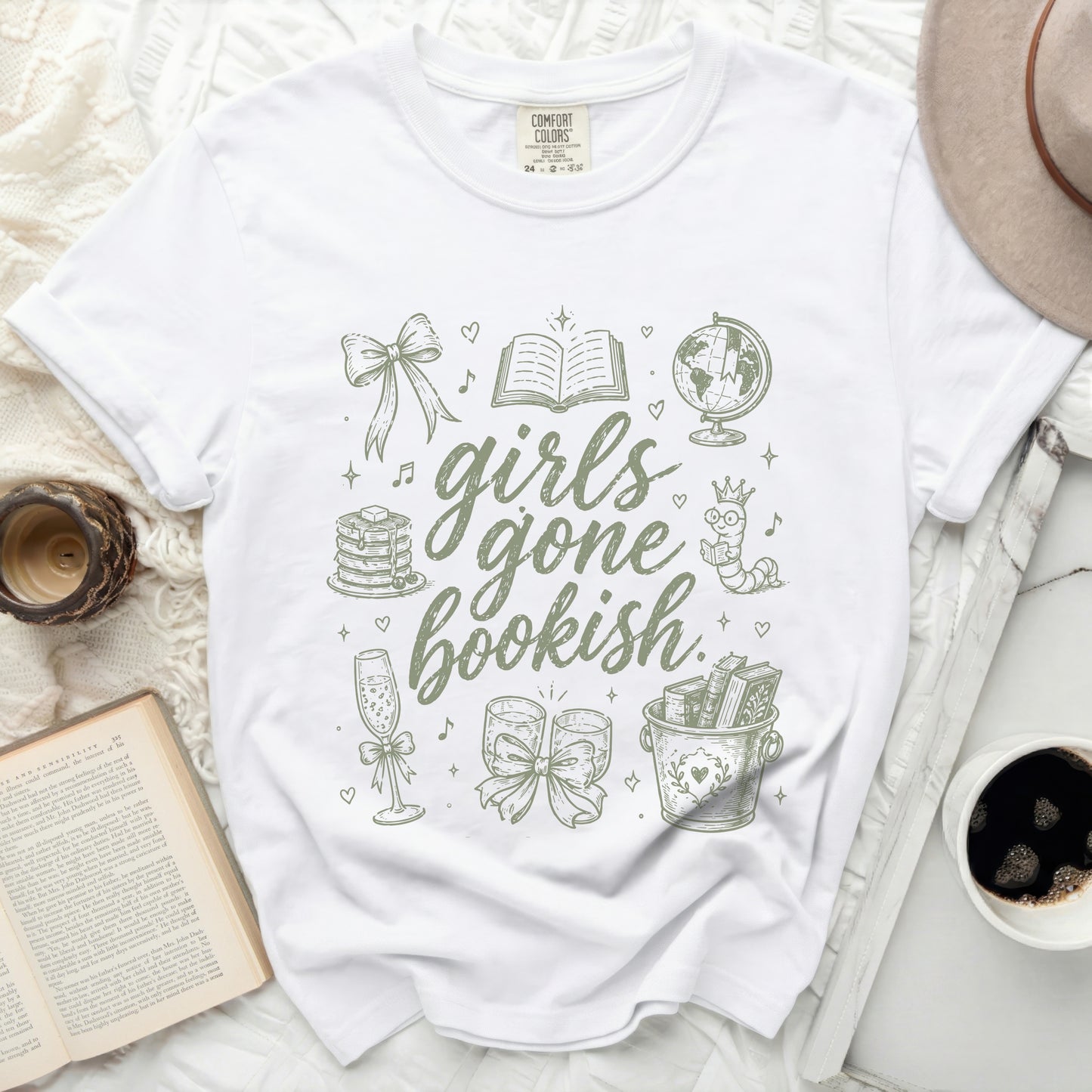 White t-shirt with "girls gone bookish" graphic featuring books, globe, and hearts.