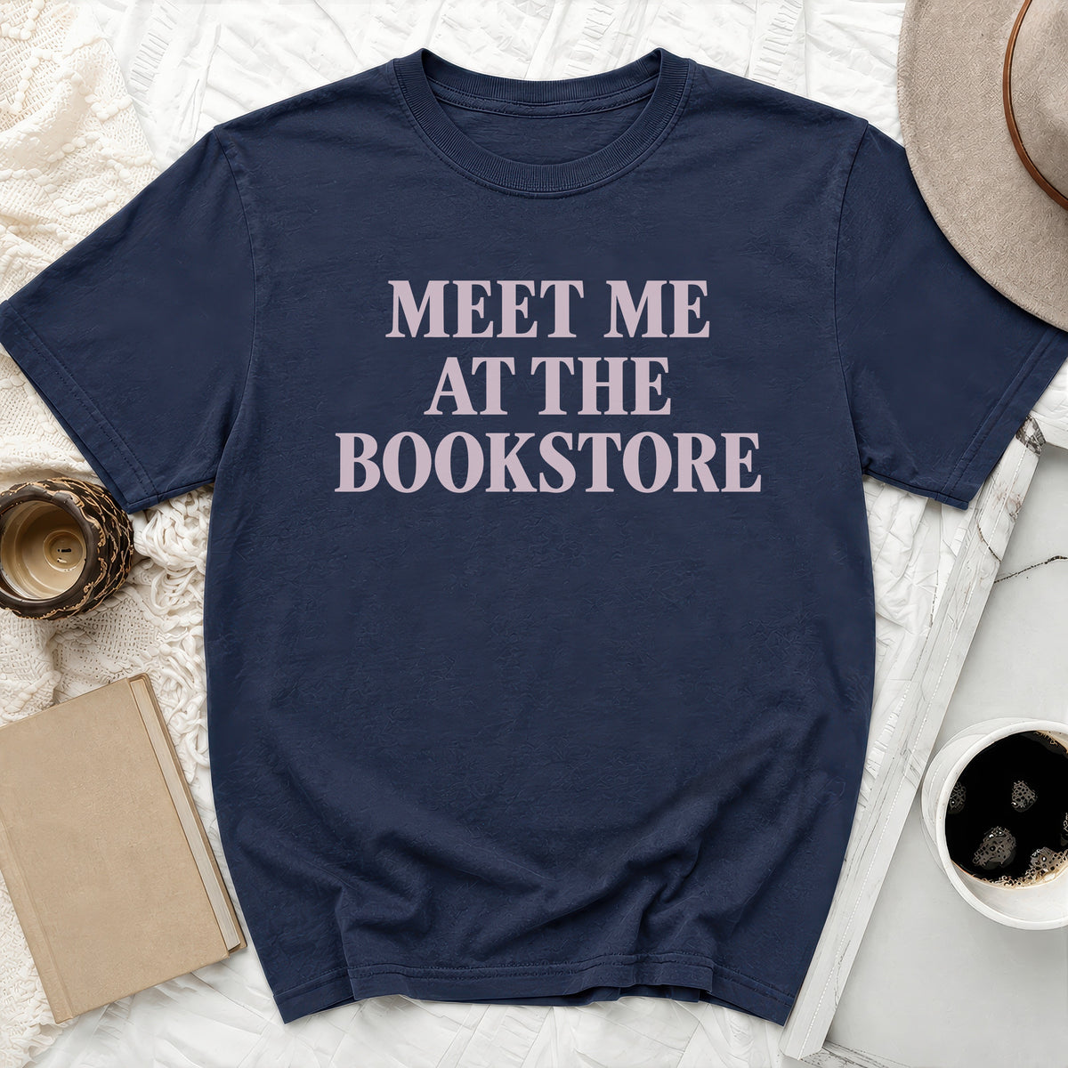 Navy t-shirt with "Meet Me At The Bookstore" text in light pink.