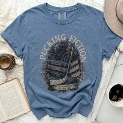 T-shirt with hockey gear, books, and text "Puck Fiction."