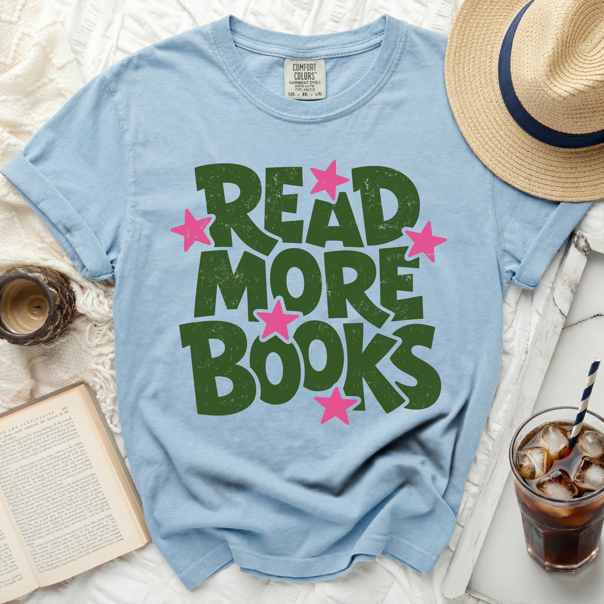 Light blue t-shirt with "READ MORE BOOKS" in green with pink stars.