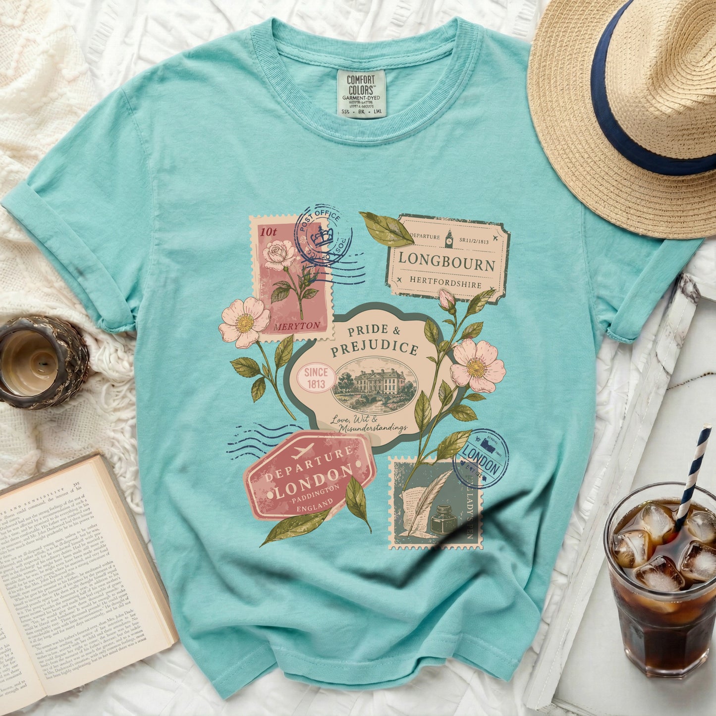 Turquoise t-shirt with vintage postage stamps, flowers, and Pride & Prejudice text.