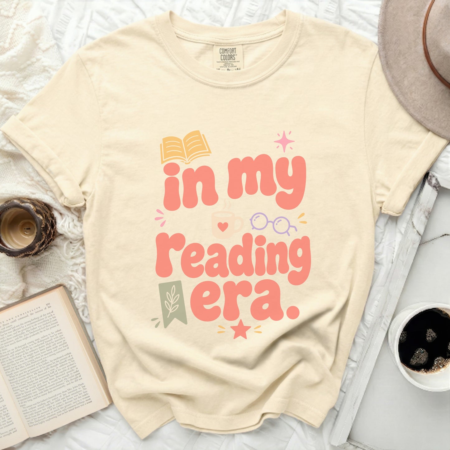 T-shirt with "in my reading era" text and book graphics.