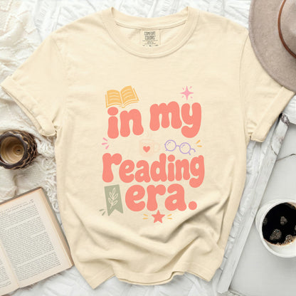 T-shirt with "in my reading era" text and book graphics.