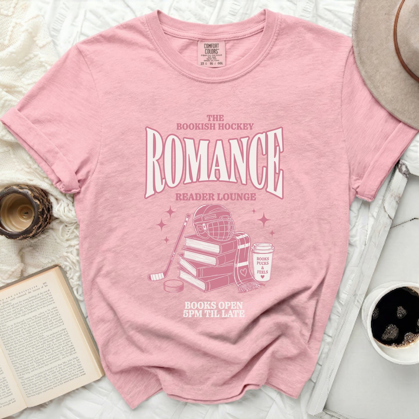Pink t-shirt with "The Bookish Hockey Romance Reader Lounge" text.