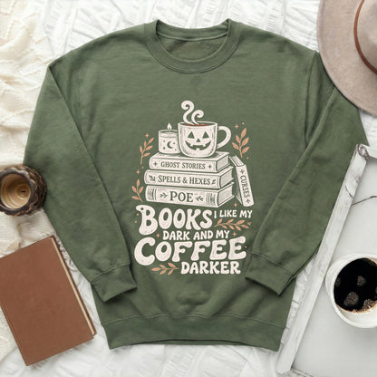 Green sweatshirt with "Books I like my coffee darker" Halloween graphic.