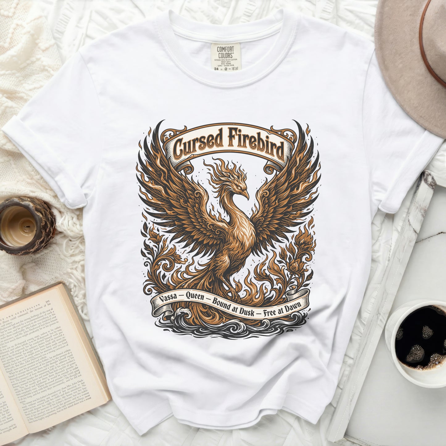 White t-shirt with a detailed graphic of a "Cursed Firebird" and text.