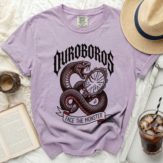 Purple t-shirt with snake, mirror, and text "OUROBOROS FACE THE MONSTER".