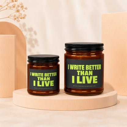 Two amber jars with black lids display "I WRITE BETTER THAN I LIVE" on black labels.
