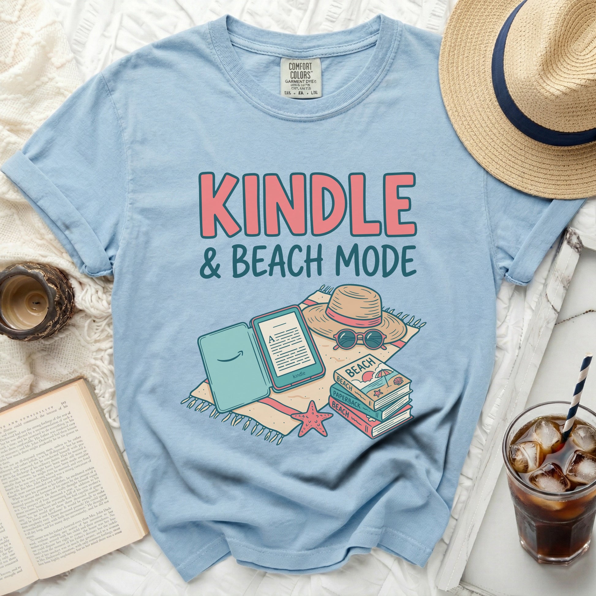 Light blue t-shirt with "KINDLE & BEACH MODE" graphic.