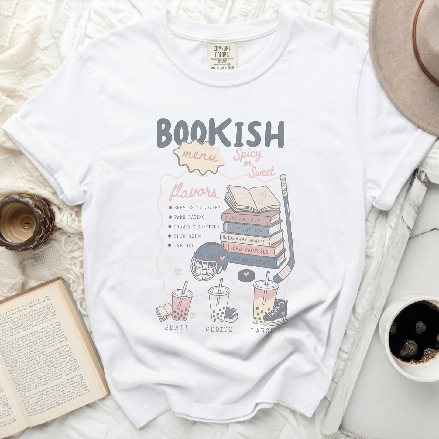 White t-shirt with "Bookish Menu" and romance novel tropes in pastel colors.