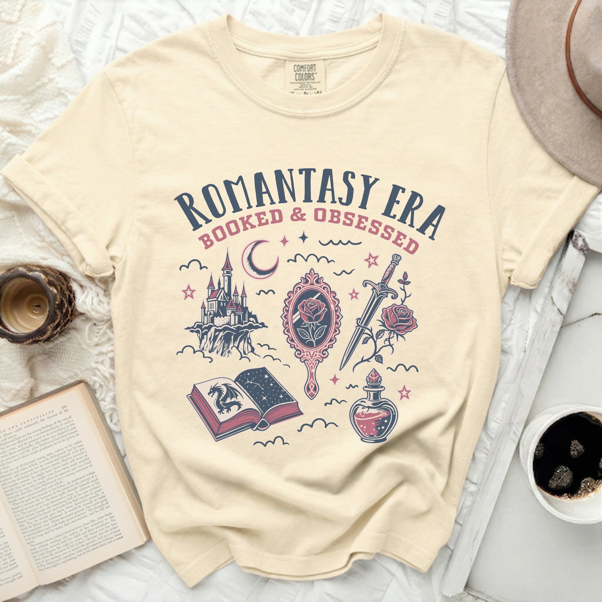Cream t-shirt with "ROMANTASY ERA BOOKED & OBSESSED" graphic.