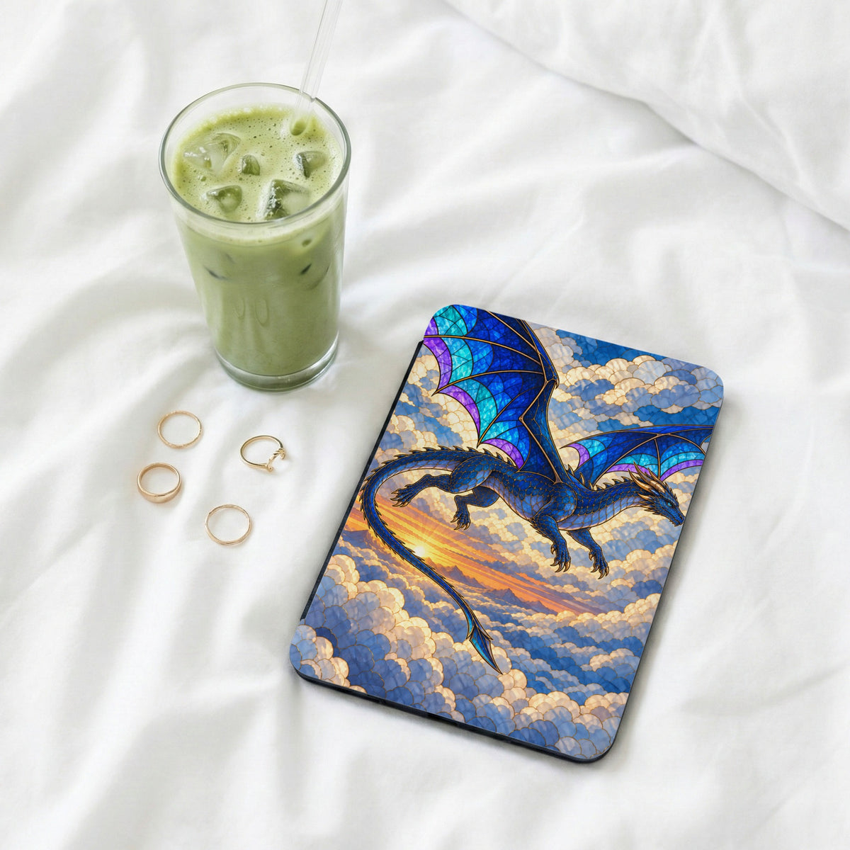 Mousepad featuring a blue dragon flying through clouds at sunset.