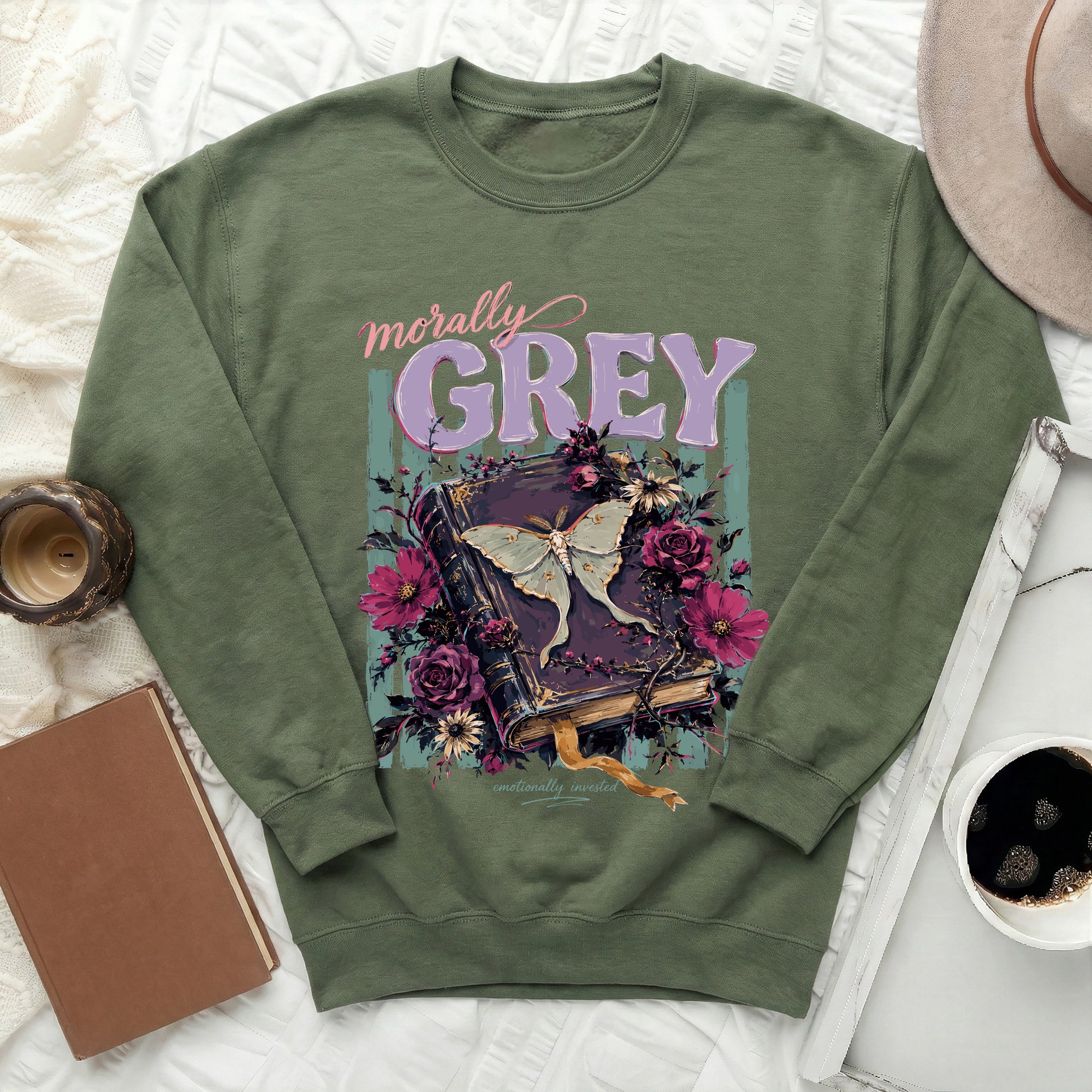 Green sweatshirt with "morally GREY emotionally invested" text and a moth on a book.
