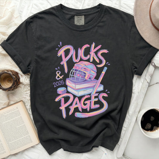 T-shirt with "Pucks & 2026 PAGES" text, hockey puck, and books.