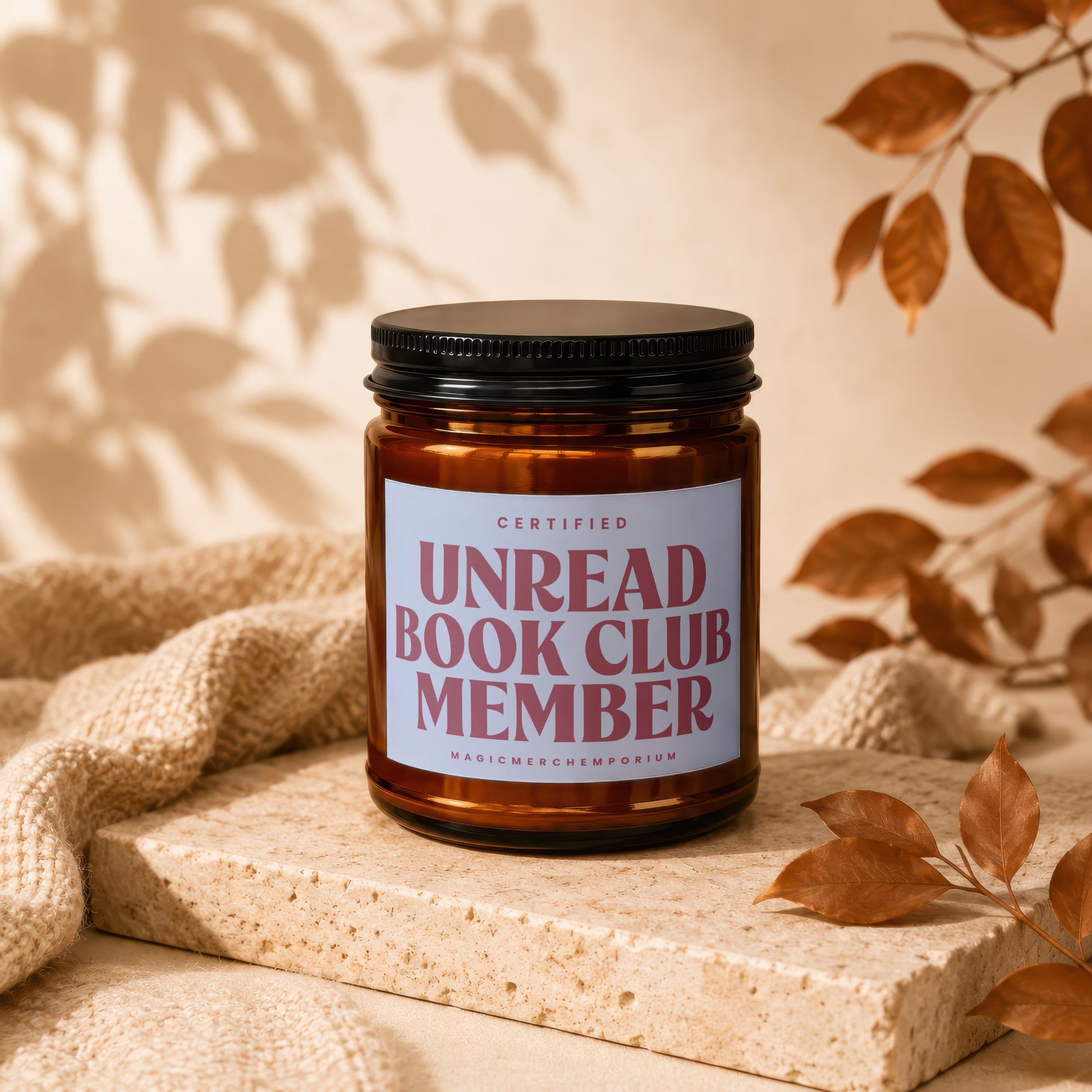 Amber jar candle reading "Certified Unread Book Club Member".