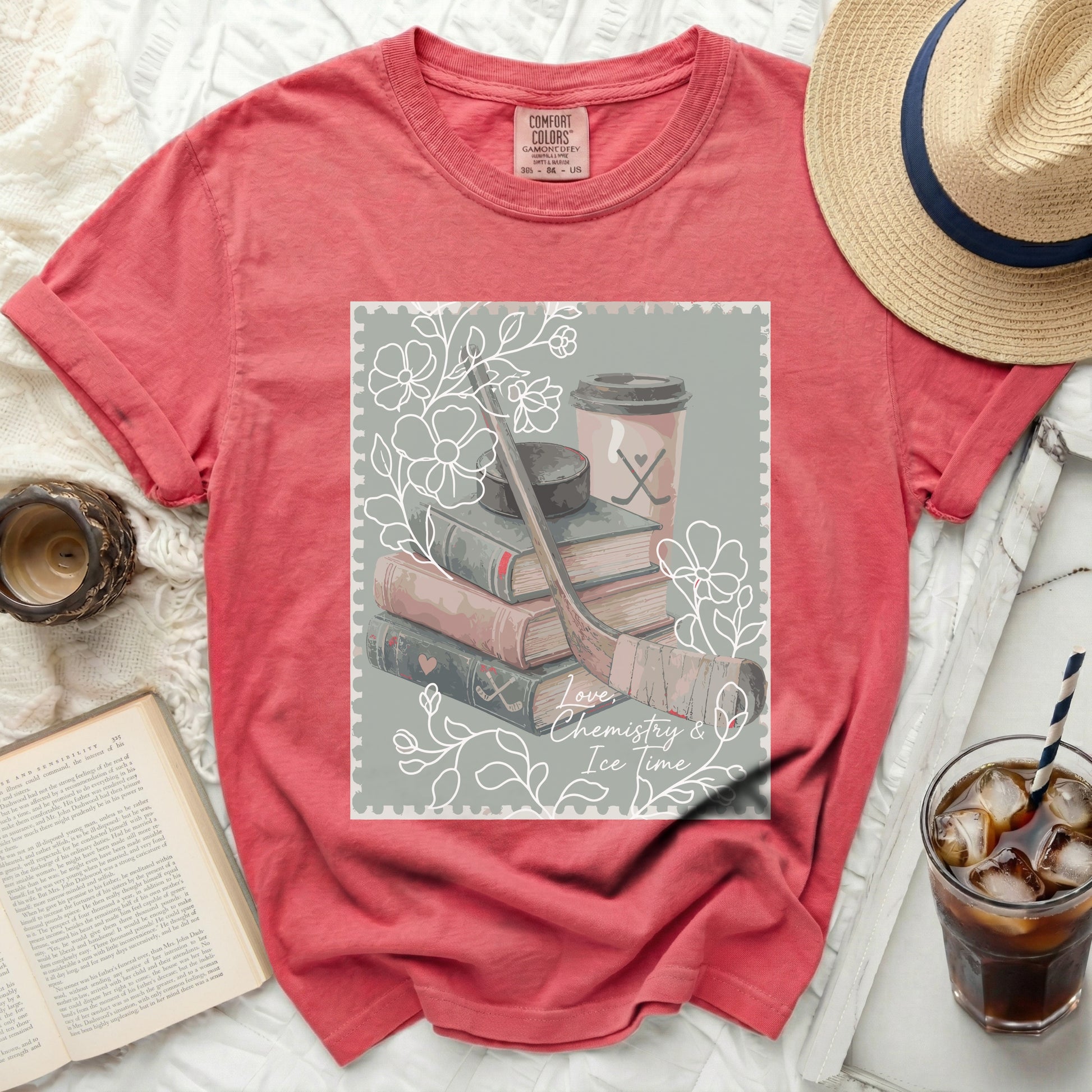 T-shirt with graphic of hockey stick, books, coffee cup, and text "Love, Chemistry & Ice Time".