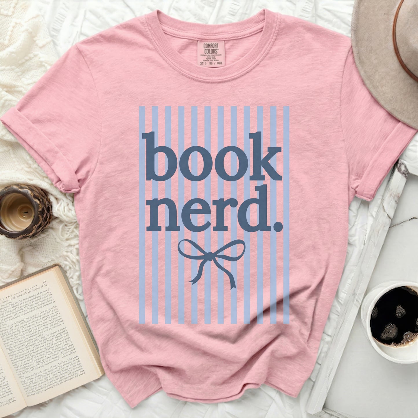 Pink t-shirt with blue stripes and "book nerd." text.